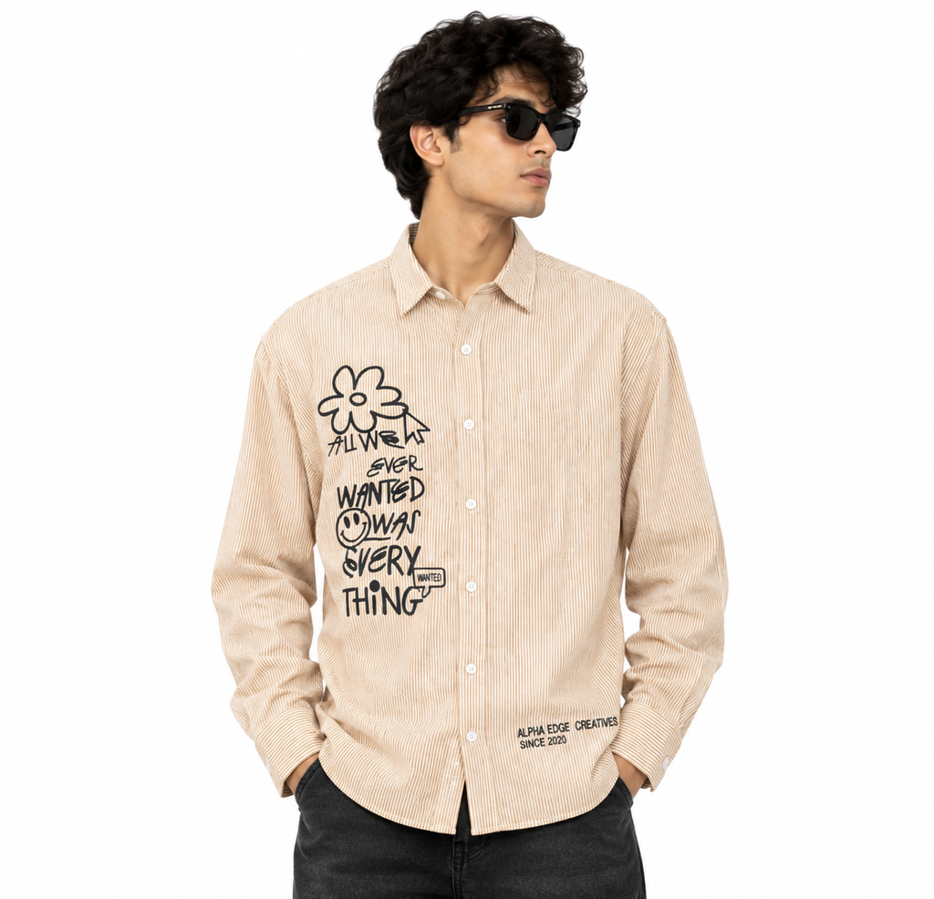 Front view of beige striped boxy-fit shirt with black graphic artwork