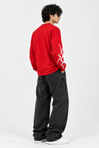 Rear angled view of red graphic long-sleeve T-shirt